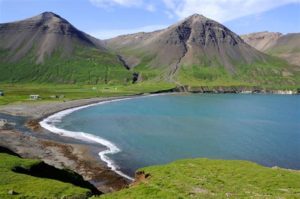 A lake surrounded by mountainous landscape in Iceland