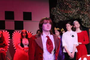 Kay plays the Knave of Hearts in The Mount's 2021 production of Alice in Wonderland, with an expressive face as her character silently stands trial